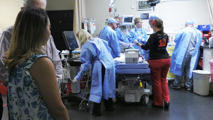 A mother looks on as the pediatric trauma team at Orlando Health Arnold Palmer Hospital for Children cares for her son. A new survey shows that 90 percent of Americans think parents should be able to stay with their child rather than being confined to a waiting room.