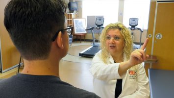 Linda Papa, MD, performs cognitive testing on a patient. She led a study at Orlando Health that found that college football players who had issues with things like memory and balance also had elevated biomarkers in their blood that indicate evidence of brain injuries.